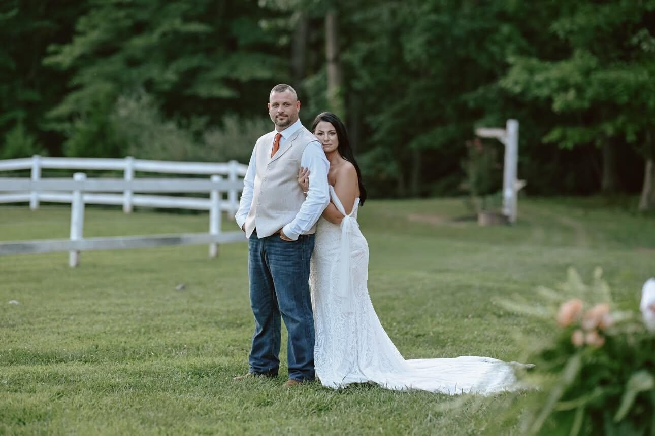 Couple walking along a white fence